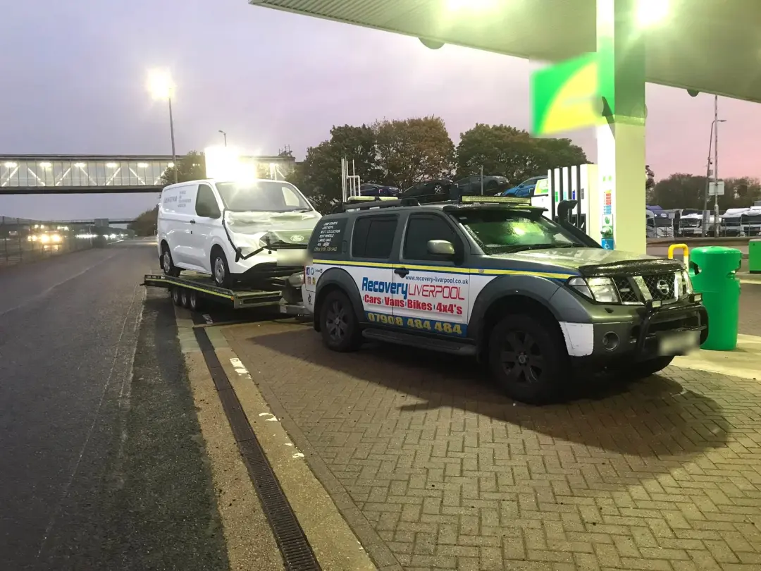Accident recovery and storage: accident-damaged van on our car transporter trailer, towed by our recovery 4x4