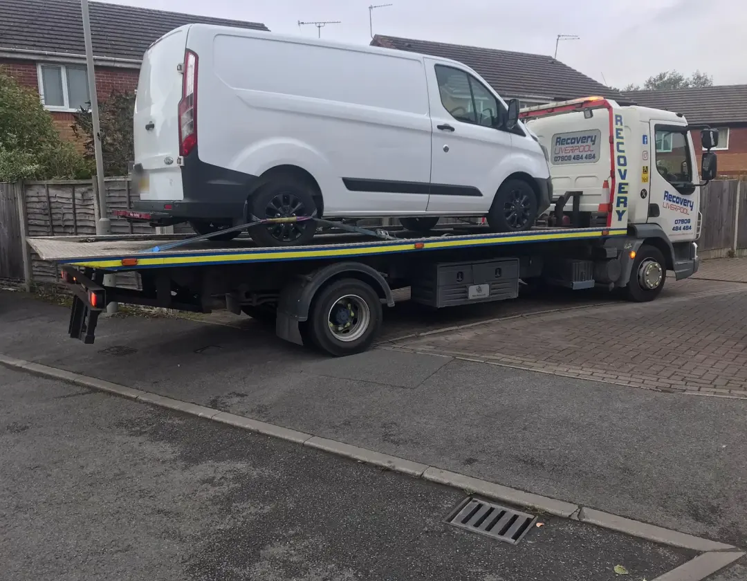 Commercial van recovery: white van strapped onto our recovery truck